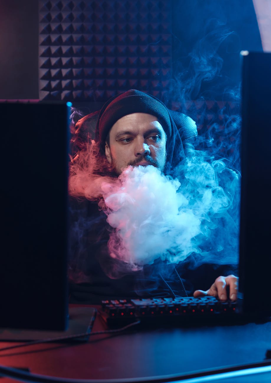 man among smoke at computer